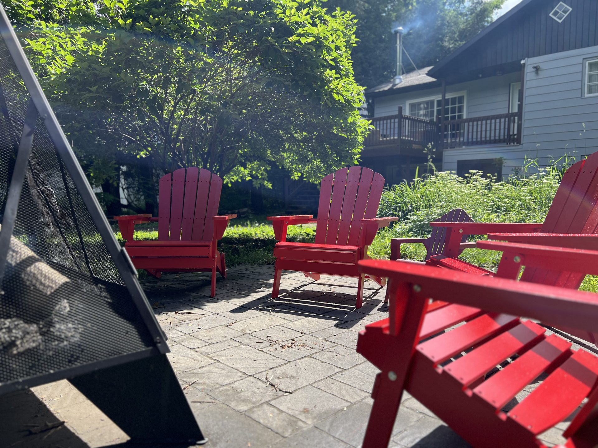 Backyard fire pit with Adirondack chairs
