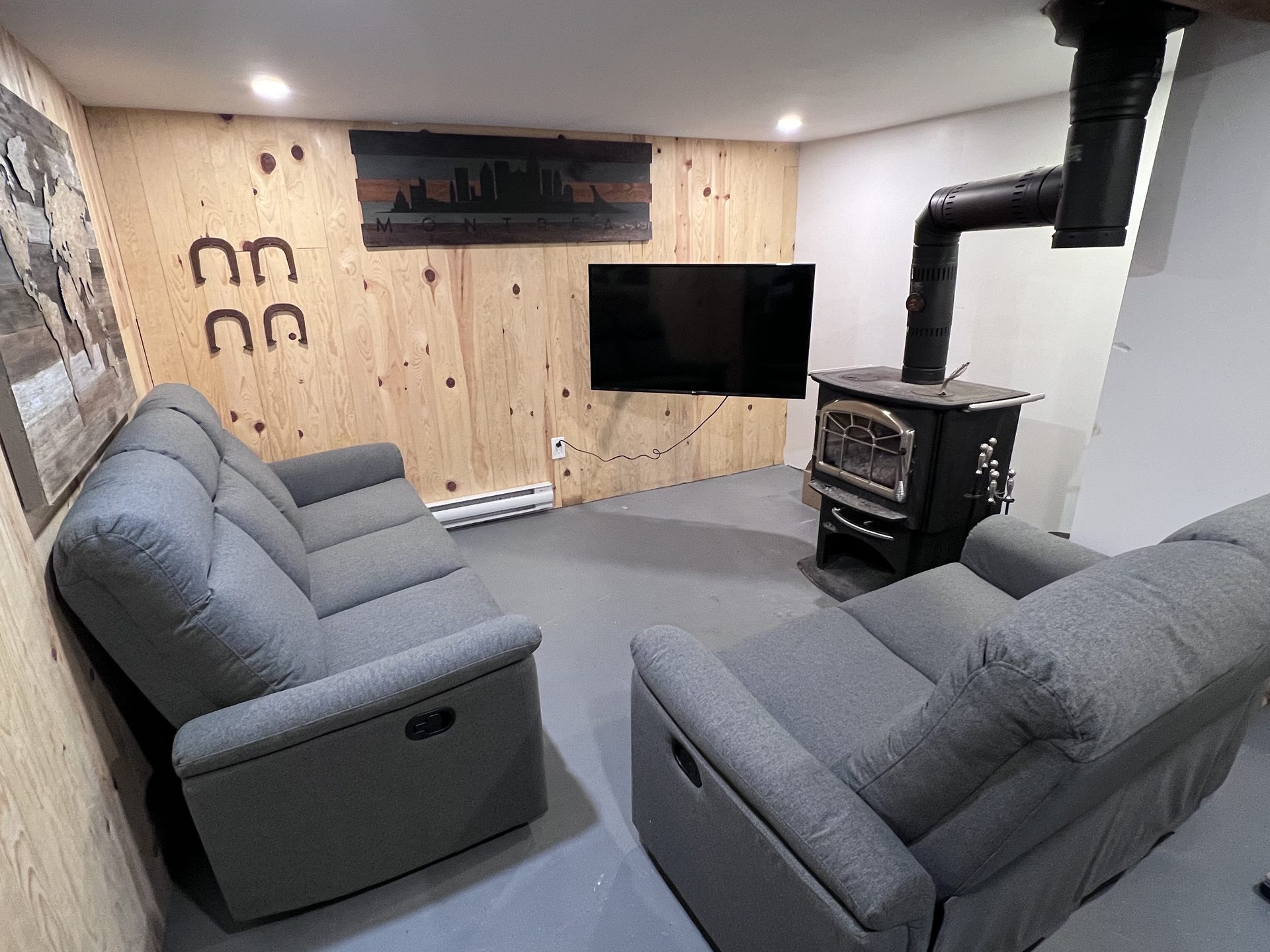 Basement lounge with TV and wood stove