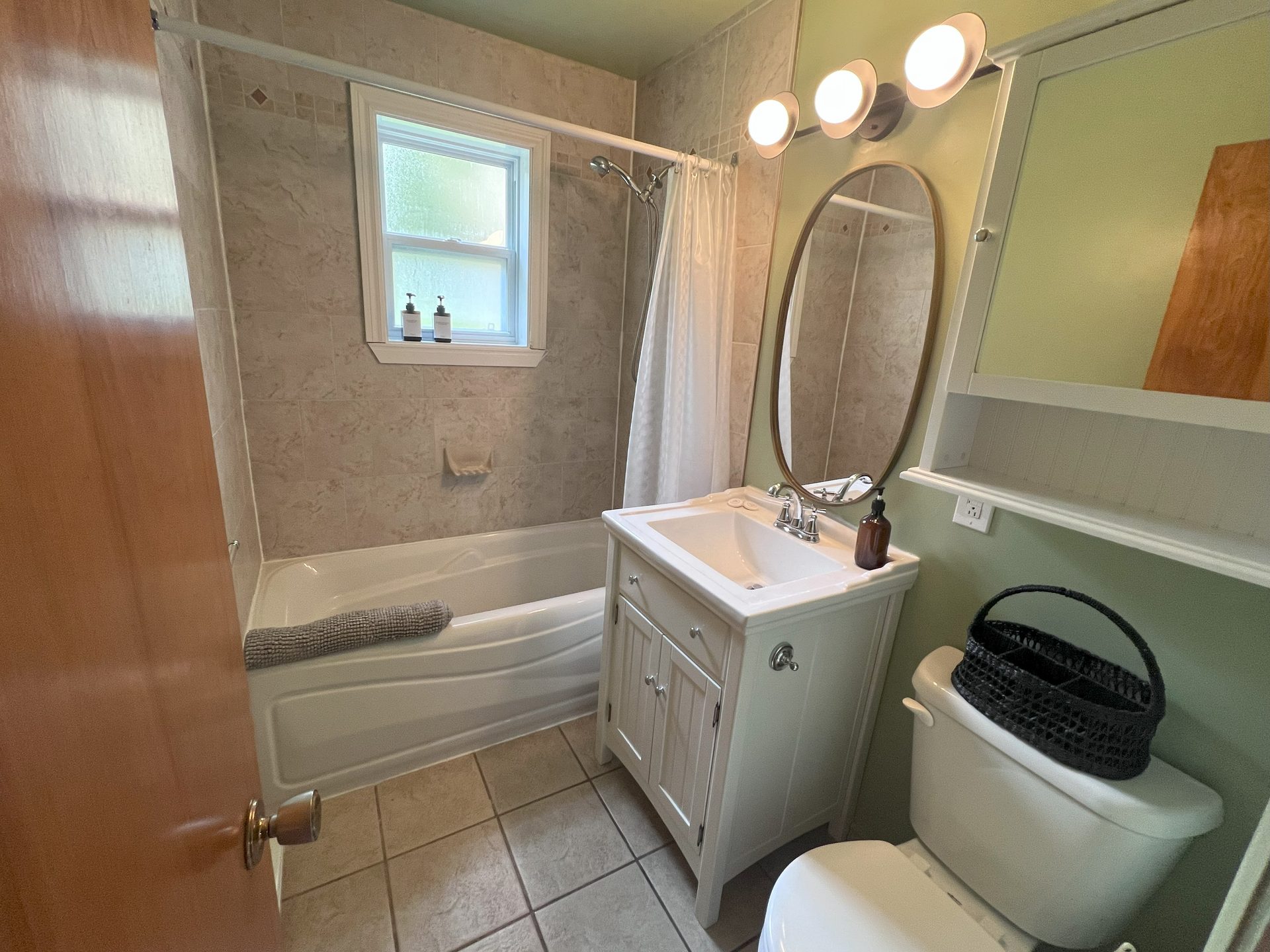 Renovated bathroom with tub and vanity